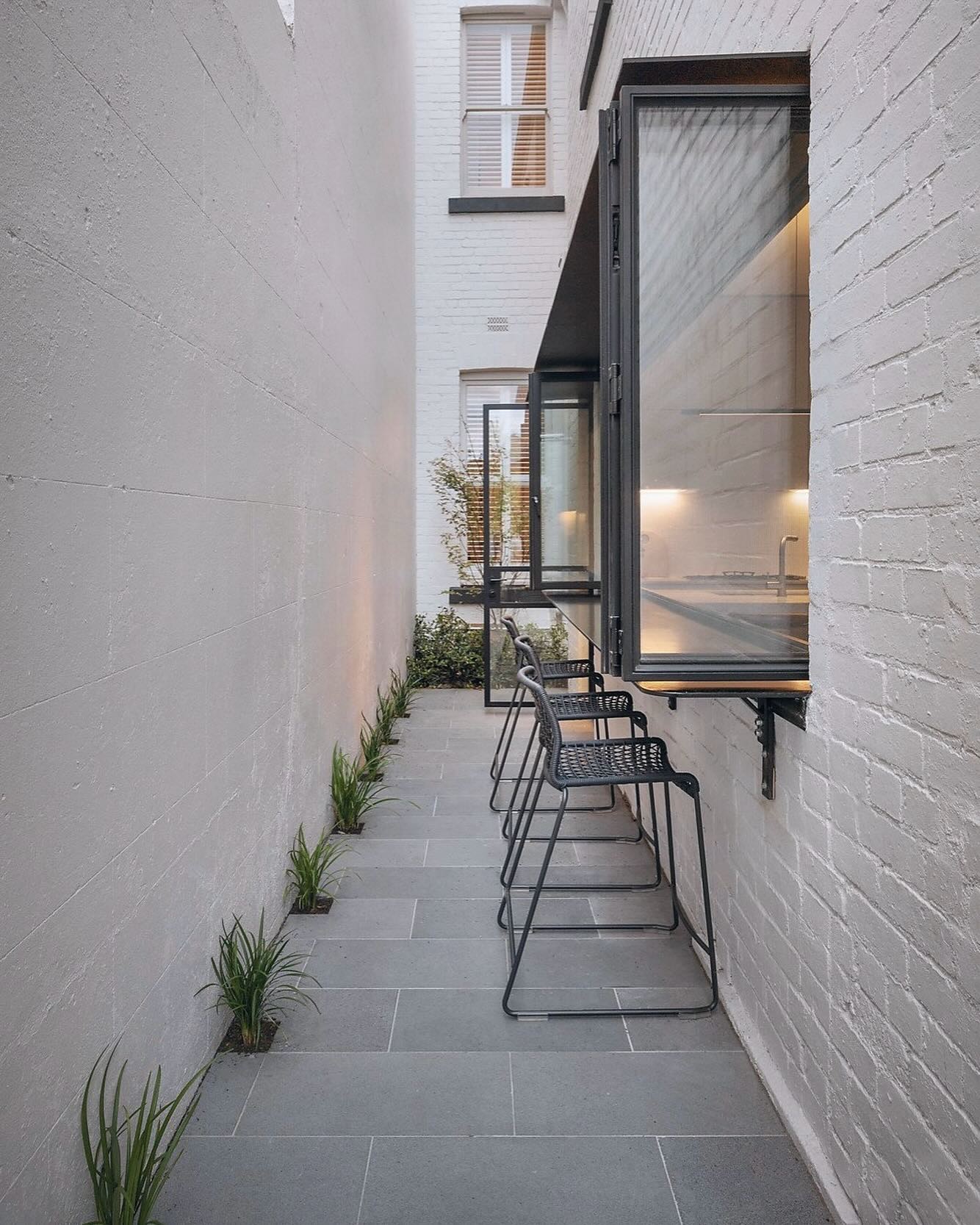 Narrow courtyard paving by Bentley Landscapes