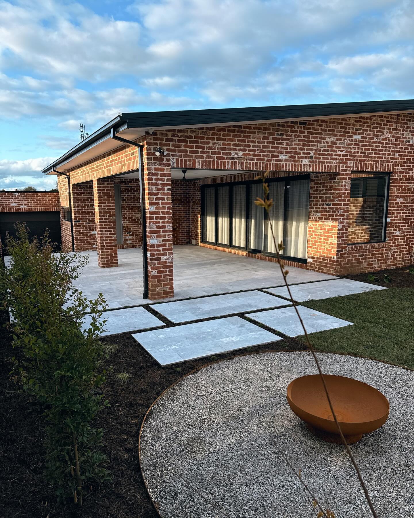 Brick home courtyard landscape by Bentley Landscapes