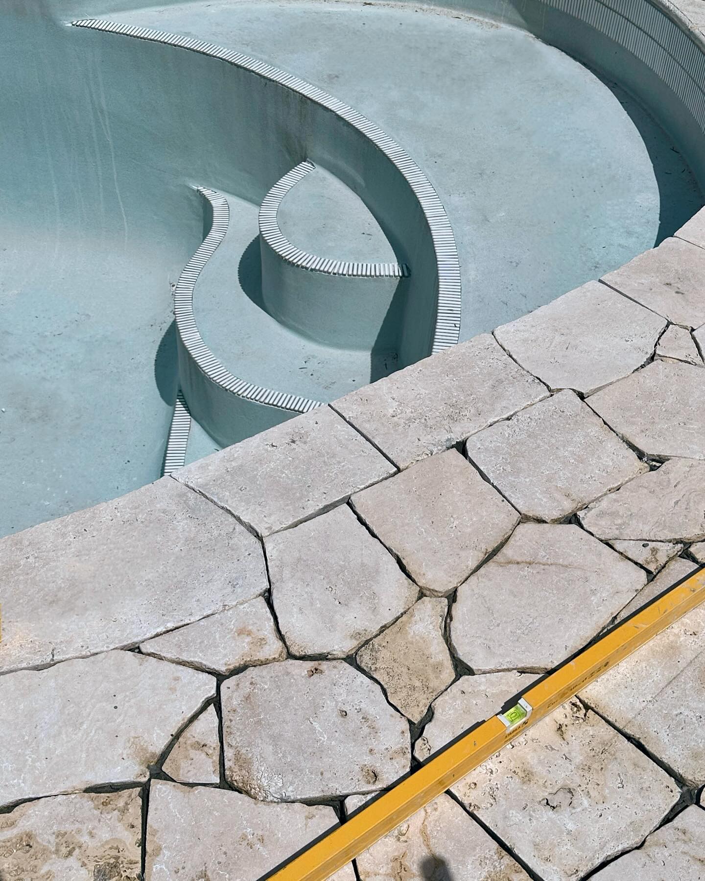Pool coping and natural stone progress by Bentley Landscapes